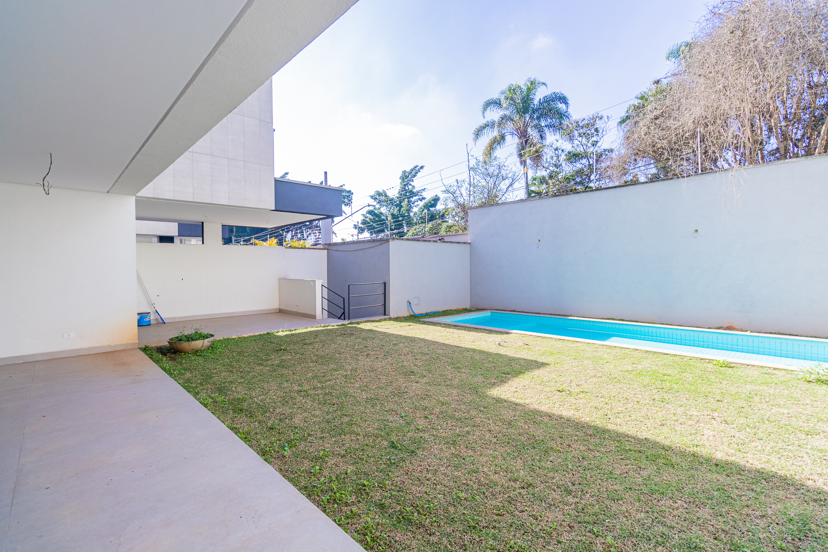 Jardim com piscina e varanda coberta